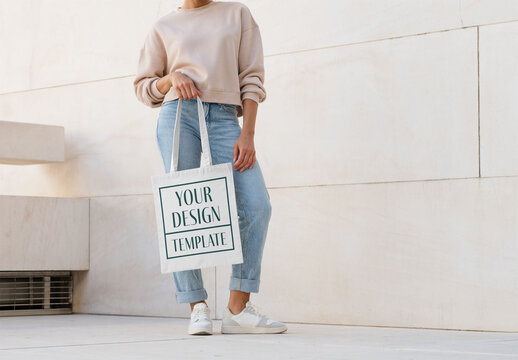 Mockup of woman carrying customizable tote bag, low section