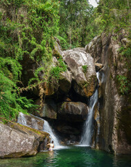 Fototapeta na wymiar Exploring the Hidden Waterfall Cave in the Tropical Rainforest