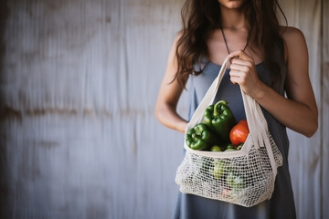 Girl is holding mesh shopping bag with vegetables, greens without plastic bags. Zero waste, plastic free Eco friendly concept. Handmade macrame bag. Sustainable lifestyle. - obrazy, fototapety, plakaty