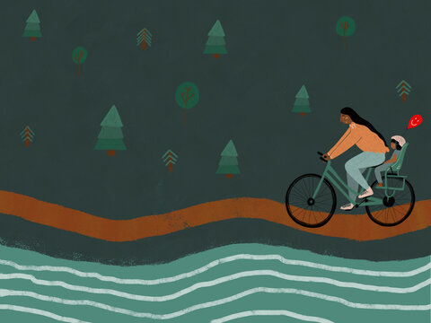 Man cycling with child and balloon in forest