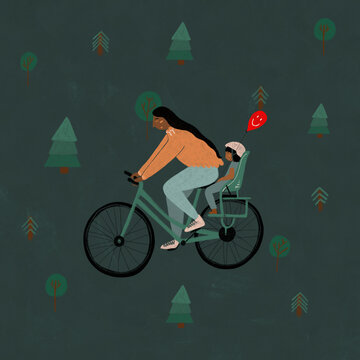 Woman cycling with child and balloon in forest