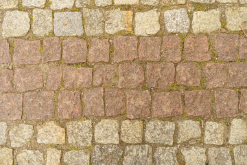 The road is paved with square granite stones.