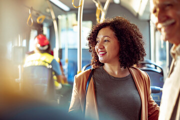Joyful woman enjoying her commute on a city bus