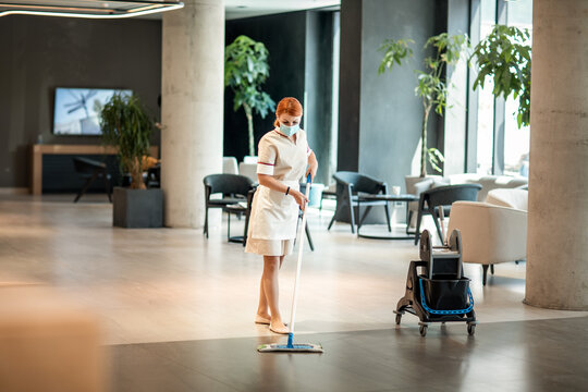 Hotel staff ensuring cleanliness in the lounge area