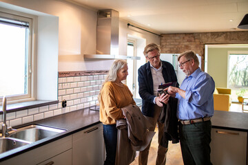 Senior couple consulting their financial advisor about their new house