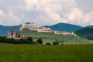 Fototapeta na wymiar Behind the village of Baldovce in the direction of Spišské Podhradie, a view of the scenery of Spišská Kapitula and Spišské Castle opens up.