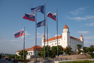 The flags of the European Union and the Slovak Republic fly in front of the Bratislava Castle building.