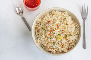 Asian fried Rice in a Bowl with Condiments Directly Above Photo
