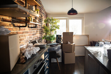 Kitchen interior with moving boxes and unpacked items