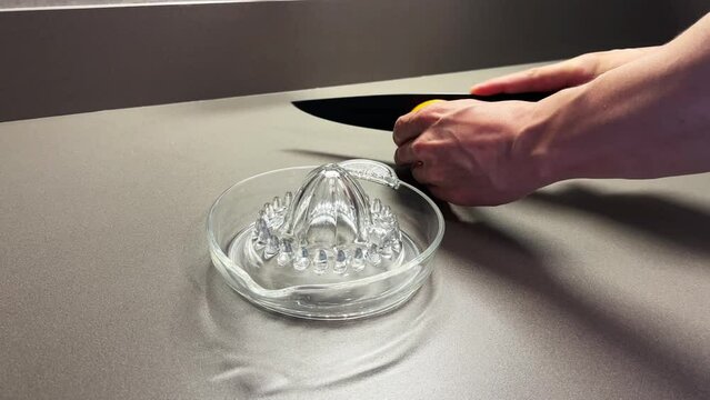 Glass juice extractor (citrus reamer) and orange.