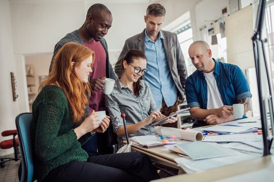 Diverse team of architects collaborating with enthusiasm in a studio - Powered by Adobe