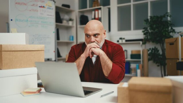 Male small business owner feeling exhaustion at work, getting bad news, problems