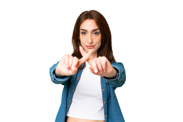 Young caucasian woman over isolated chroma key background making stop gesture with her hand to stop...