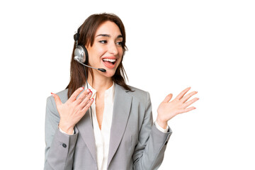 Telemarketer caucasian woman working with a headset over isolated chroma key background with...