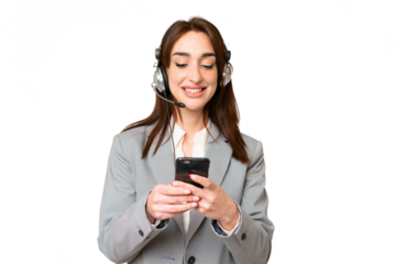 Telemarketer caucasian woman working with a headset over isolated chroma key background sending a message with the mobile