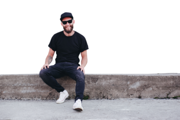 Hipster handsome male model with beard wearing black blank t-shirt with space for your logo or design in casual urban style