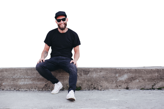 Hipster handsome male model with beard wearing black blank t-shirt with space for your logo or design in casual urban style