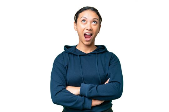 Young Uruguayan woman over isolated chroma key background looking up and with surprised expression