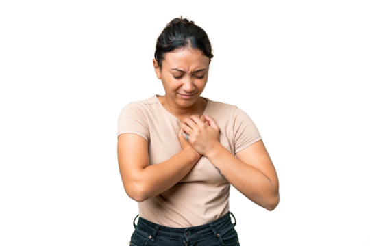 Young Uruguayan woman over isolated chroma key background having a pain in the heart