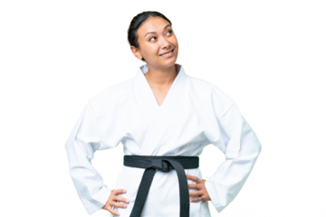 Young Uruguayan woman doing karate over isolated chroma key background thinking an idea while looking up