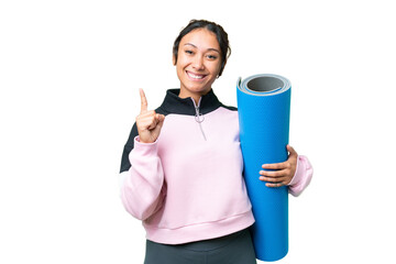 Young sport woman going to yoga classes while holding a mat over isolated chroma key background...
