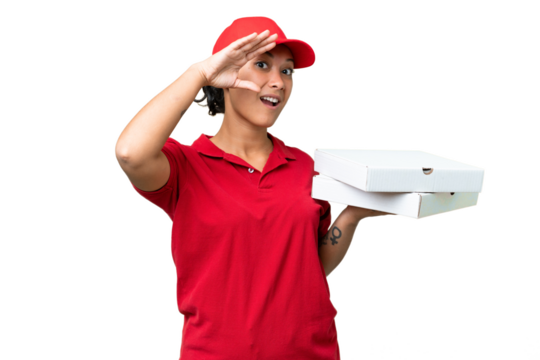 pizza delivery woman with work uniform picking up pizza boxes over isolated chroma key background doing surprise gesture while looking to the side