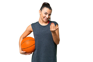 Young beauty woman over isolated chroma key background playing basketball and doing coming gesture