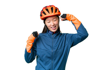 Young cyclist woman over isolated chroma key background celebrating a victory