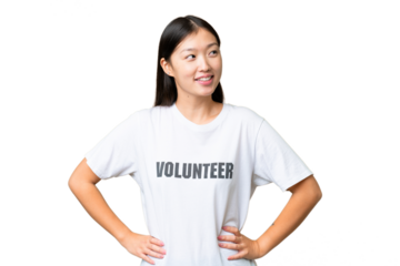 Young volunteer woman over isolated chroma key background posing with arms at hip and smiling