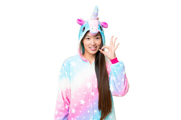 Young Asian woman with unicorn pajamas over isolated chroma key background showing ok sign with fingers
