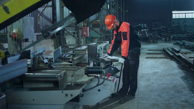 Manufacture industrial zone factory worker looking over the plan of work and make some notes he wearing safety equipment and helmet