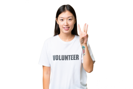Young volunteer woman over isolated chroma key background happy and counting three with fingers
