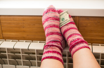 Feet in warm winter socks warm up on the radiator.