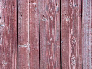 Old plank wooden wall made of boards. Old wooden boards with red nails with peeling paint abstract texture background.