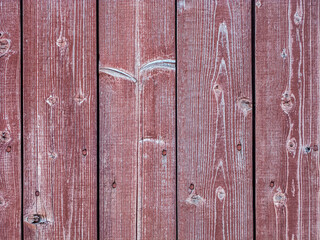 Old plank wooden wall made of boards. Old wooden boards with red nails with peeling paint abstract texture background.