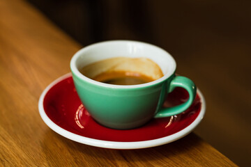 A cup of espresso coffee on the wooden table