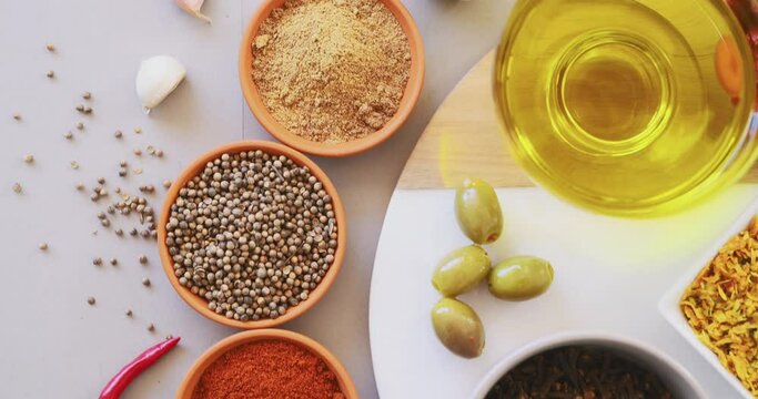 Top view, spices and curry on table in kitchen for cooking, food or seasoning collection with color. Powder, herbs and tumeric or garlic with colorful seeds, cumin and masala on arrangement board