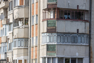 Old apartment block from communist era in Eastern Europe. Communist socialist architecture style flat. Dreary and depressive rust-eaten building. - obrazy, fototapety, plakaty