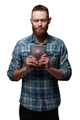 Handsone man reading and praying over Bible
