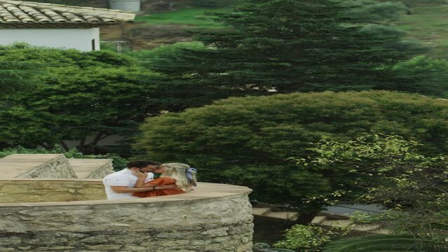 Couple relaxing and admiring scenic view at Jardines de Cuenca  - vertical video / Ronda, Malaga, Spain