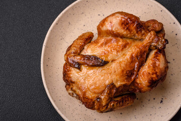 Crispy delicious whole baked chicken with vegetables, salt and spices