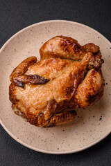 Crispy delicious whole baked chicken with vegetables, salt and spices