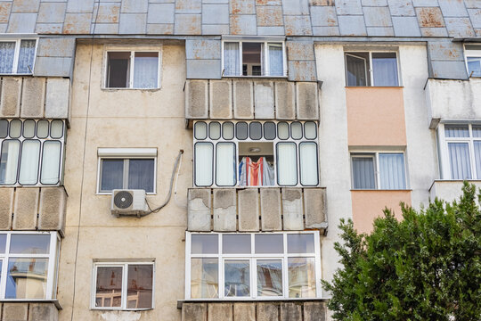 Old apartment block from communist era in Eastern Europe. Communist socialist architecture style flat. Dreary and depressive rust-eaten building.