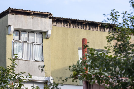 Balcony from old apartment block from communist era in Eastern Europe. Communist socialist architecture style flat. Dreary and depressive rust-eaten building.