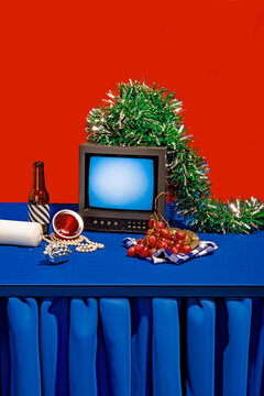 Retro TV on placed on blue table against red background