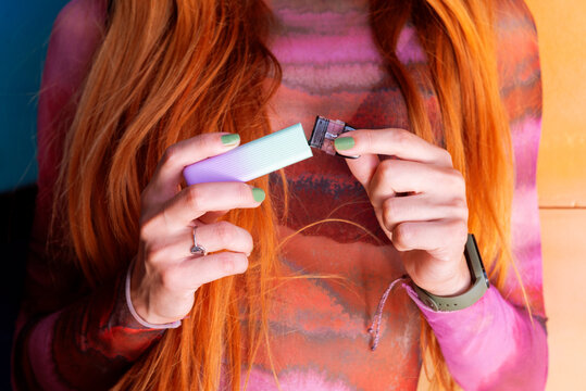 Anonymous woman with e-cigarette piece