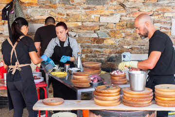 Outdoor culinary team in action while preparing octopus