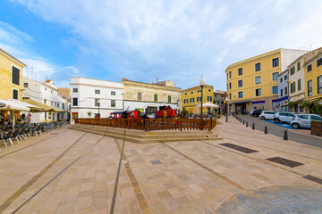 An outdoor children's playground in Plaça Bastió, a popular central plaza square in the historic center of the old town of Mahon, Spain, on the Mediterranean island of Menorca. - obrazy, fototapety, plakaty