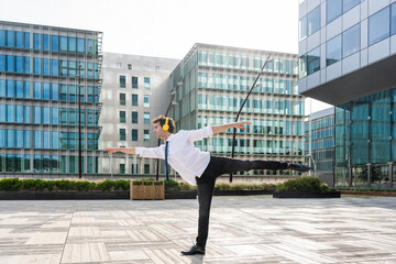 Flexible and cool businessman doing acrobatic trick