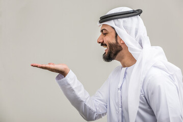 Arabian man wearing traditional emirati dishdasha kandura in studio - Portrait of middle-eastern...